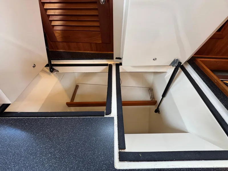 Slide: The Image of Interior storage compartments of a 2000 Sabre 362 yacht, featuring wooden accents and sleek design. - 47