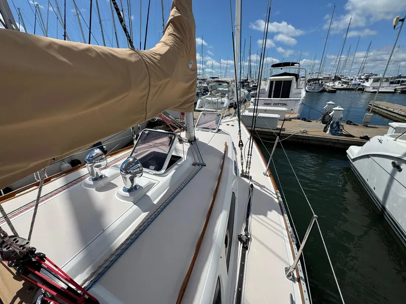 Slide: The Image of Sailboat Sabre 362, 2000 model, docked at marina with clear skies and calm waters. - 6