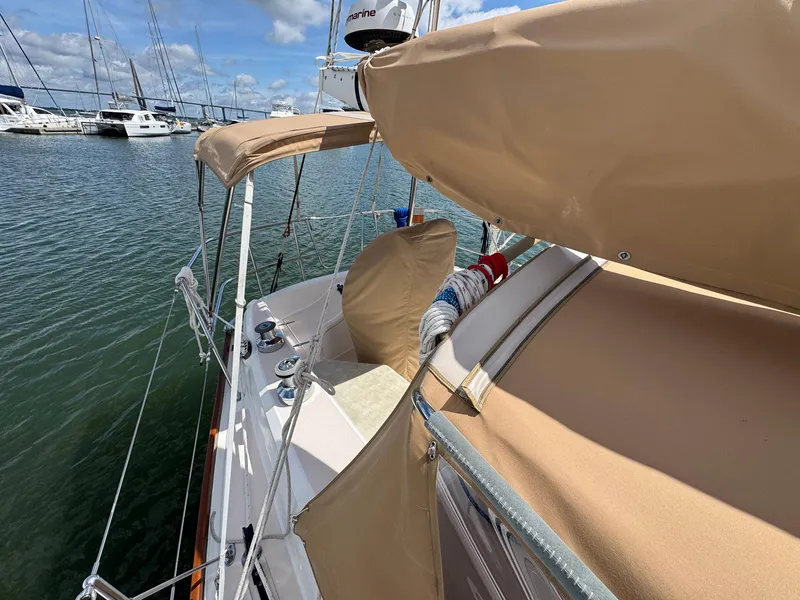 Slide: The Image of Sabre 362 sailboat from 2000 docked in marina, featuring tan covers and clear skies. - 7