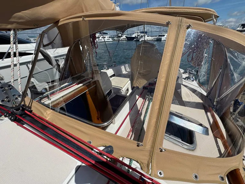 Slide: The Image of 2000 Sabre 362 sailboat cockpit with tan canvas cover and marina view. - 8