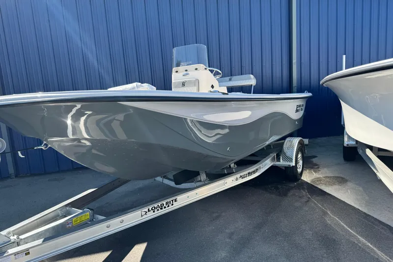 Slide: The Image of 2026 Carolina Skiff 19 LS boat on trailer, parked by blue wall. - 10