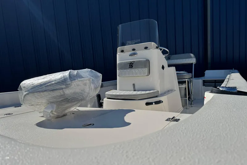 Slide: The Image of 2026 Carolina Skiff 19 LS boat interior with console and seating, wrapped components. - 11