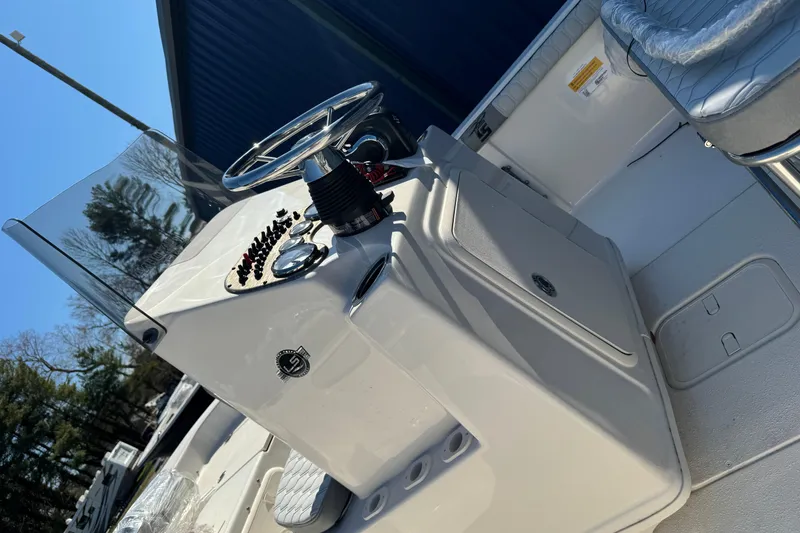 Slide: The Image of 2026 Carolina Skiff 19 LS boat console with steering wheel and controls. - 13