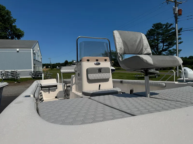 Slide: The Image of 2025 Carolina Skiff 19 LS boat with seating and console, displayed outdoors under clear blue sky. - 8