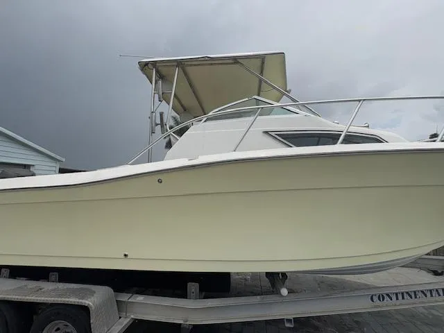 Slide: The Image of 1997 Sport-Craft 232 Sportfish boat on trailer, side view. - 4