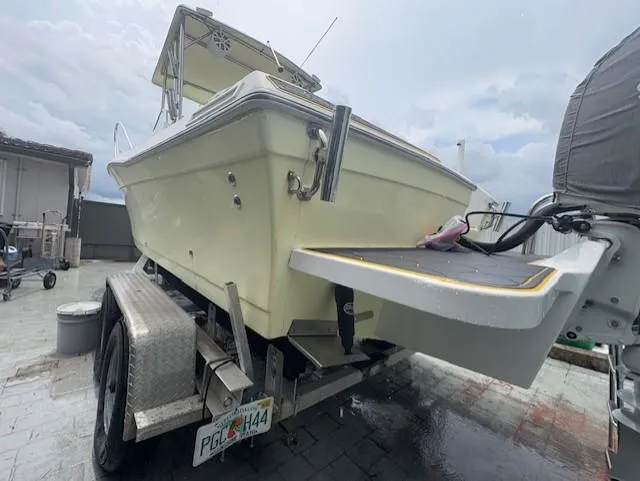 Slide: The Image of 1997 Sport-Craft 232 Sportfish boat on trailer, parked outdoors under cloudy sky. - 5