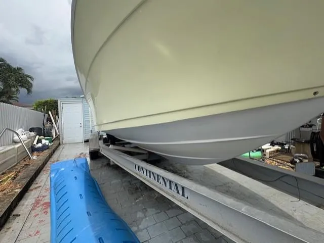 Slide: The Image of 1997 Sport-Craft 232 Sportfish boat on Continental trailer, parked outdoors. - 7