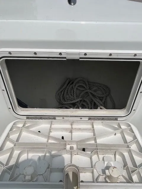 Slide: The Image of Open storage compartment on a 2006 Polar Dynasty 2100 DC boat with coiled rope inside. - 12