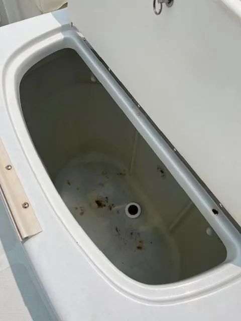 Slide: The Image of Open storage compartment on a 2006 Polar Dynasty 2100 DC boat. - 16