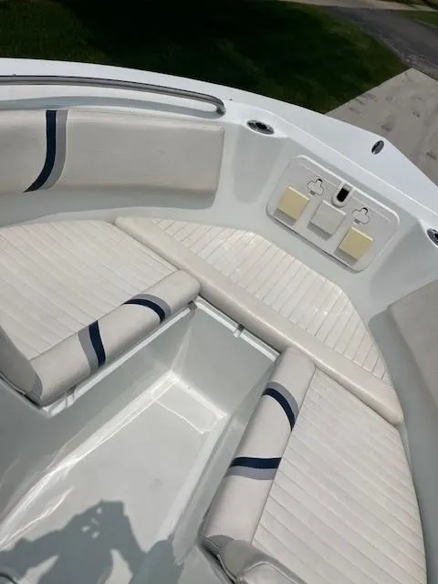 Slide: The Image of 2006 Polar Dynasty 2100 DC boat interior with white cushioned seating and blue accents. - 17