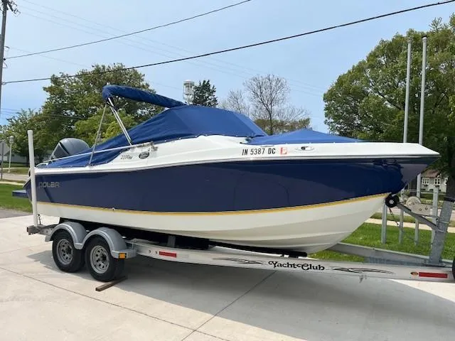 Slide: The Image of 2006 Polar Dynasty 2100 DC boat on trailer, blue and white design, parked outdoors. - 18