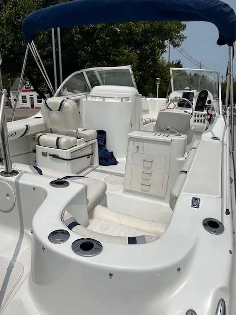 Slide: The Image of 2006 Polar Dynasty 2100 DC boat with seating, storage, and canopy in a marina setting. - 5