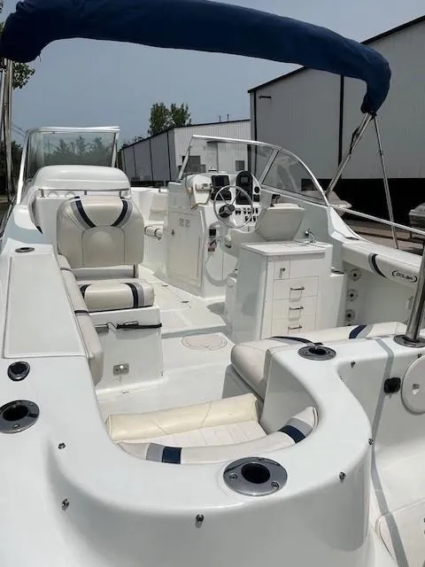 Slide: The Image of 2006 Polar Dynasty 2100 DC boat with seating, steering console, and blue canopy. - 6