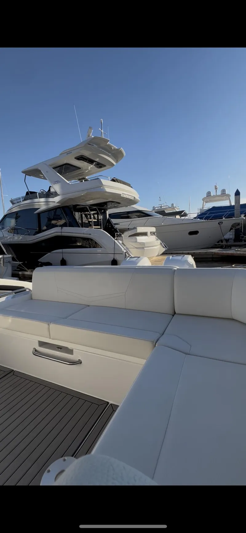 Slide: The Image of 2020 Cruisers Yachts 338OB at marina, featuring sleek design and luxurious seating. - 17