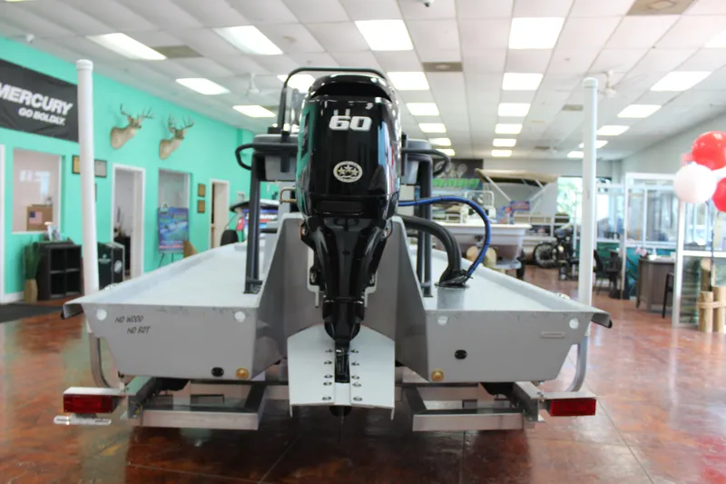 Slide: The Image of 2026 Freedom Boats Chiquita on trailer, featuring a spacious deck and cooler storage. - 4