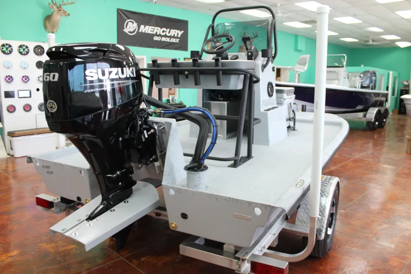 Slide: The Image of 2026 Freedom Boats Chiquita, white deck, parked outdoors, showcasing sleek design and modern features. - 5