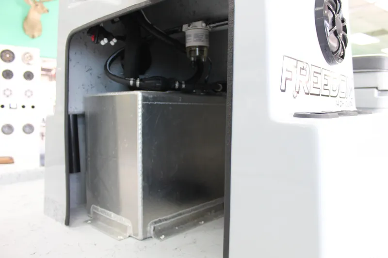 Slide: The Image of 2026 Freedom Boats Chiquita dashboard with steering wheel and controls, outdoor display. - 11