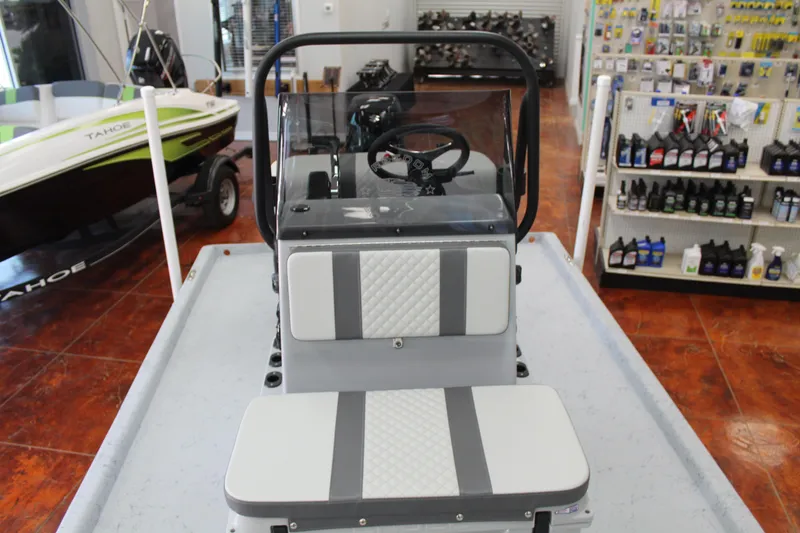 Slide: The Image of 2026 Freedom Boats Chiquita on trailer, featuring Suzuki outboard motor, parked outdoors. - 16