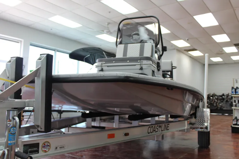 Slide: The Image of 2026 Freedom Boats Chiquita with Suzuki engine on trailer at dealership. - 2