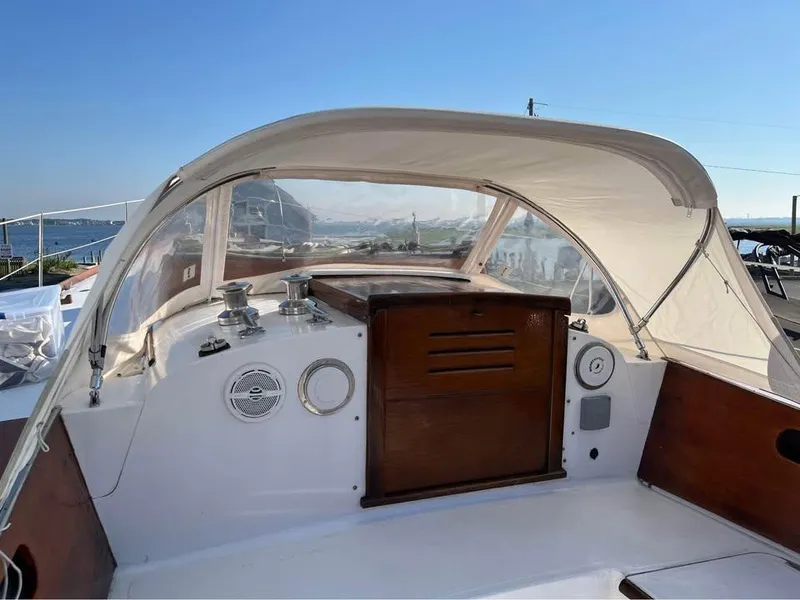 Slide: The Image of 1968 Hinckley Bermuda 40 sailboat cockpit with canopy, featuring wooden accents and ocean view. - 12