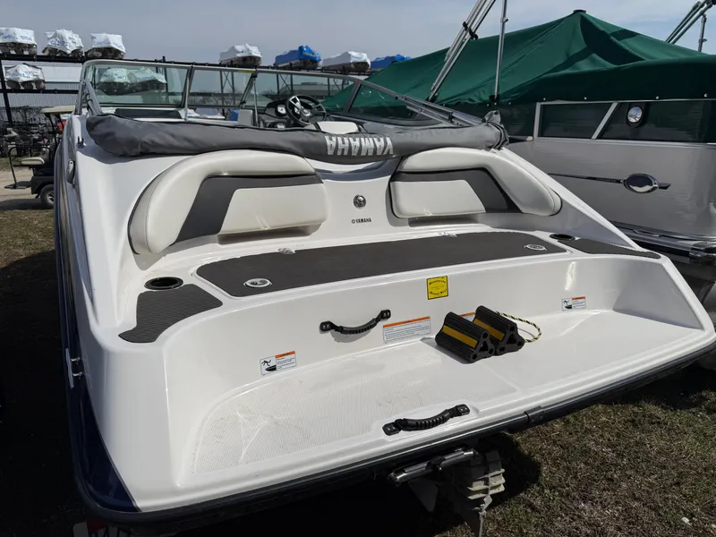 Slide: The Image of 2016 Yamaha Boats SX190, rear view, showcasing seating and deck features. - 1