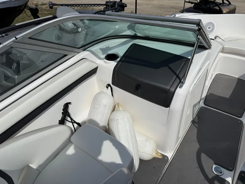 Slide: The Image of 2016 Yamaha Boats SX190 interior with white seating and windshield, featuring boat fenders. - 4