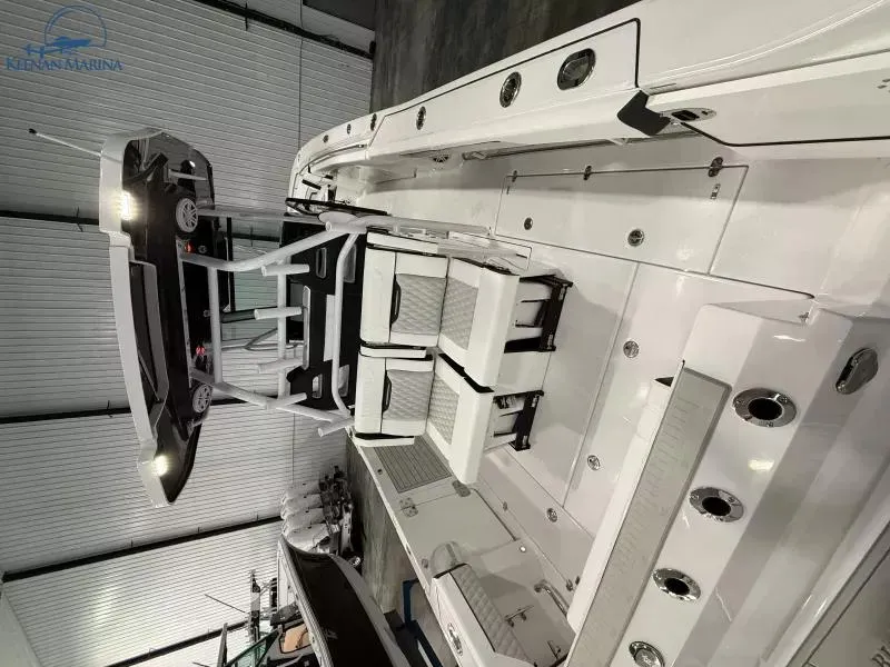 Slide: The Image of 2025 Blackfin 332 CC boat interior with white seating and modern design. - 14