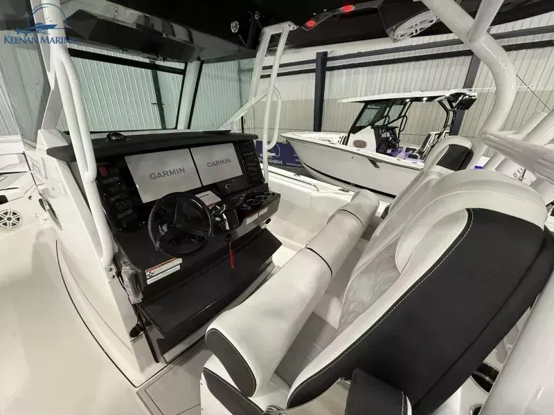 Slide: The Image of 2025 Blackfin 332 CC boat interior with Garmin navigation system and sleek seating. - 5