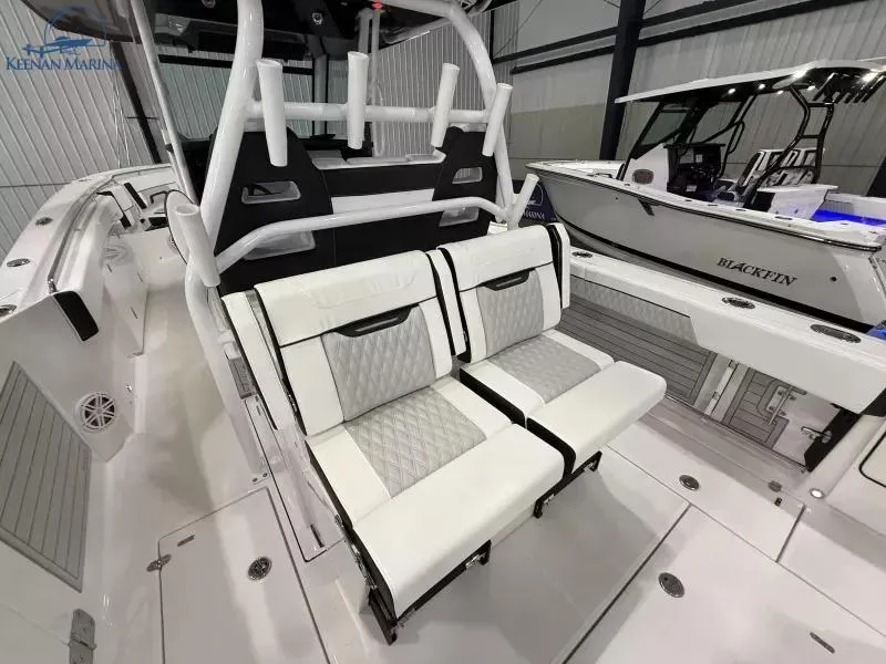 Slide: The Image of 2025 Blackfin 332 CC boat interior with white seating and modern design. - 6