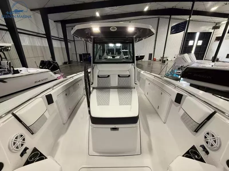 Slide: The Image of 2025 Blackfin 332 CC boat interior, sleek design, spacious seating, modern features, showroom display. - 9