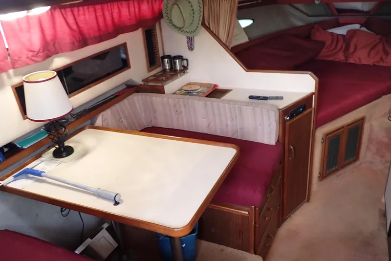 Slide: The Image of Interior of 1987 Sea Ray 300 Weekender with dining area and cozy sleeping quarters. - 10
