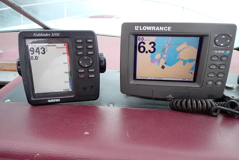 Slide: The Image of Garmin and Lowrance navigation devices on 1987 Sea Ray 300 Weekender boat dashboard. - 18