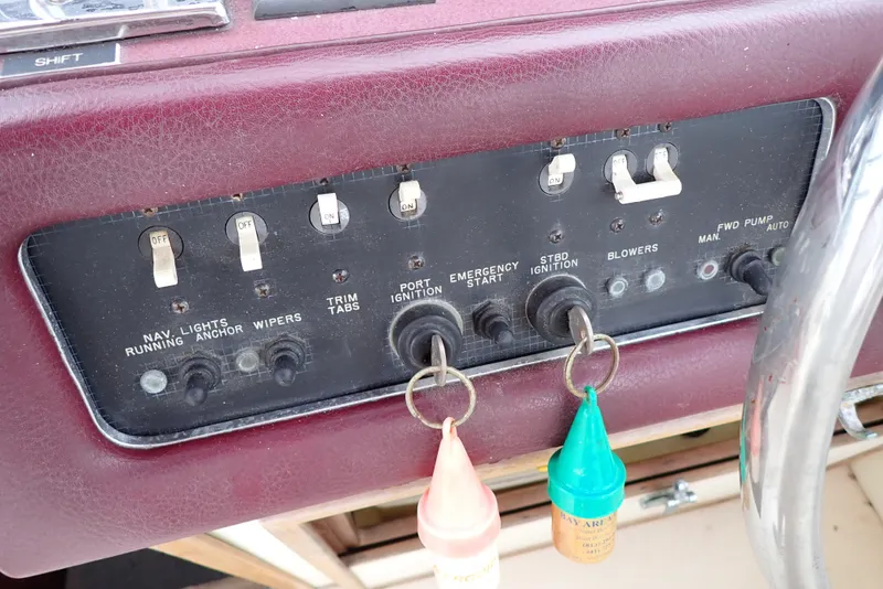 Slide: The Image of Control panel of a 1987 Sea Ray 300 Weekender boat with ignition switches and labeled toggles. - 20