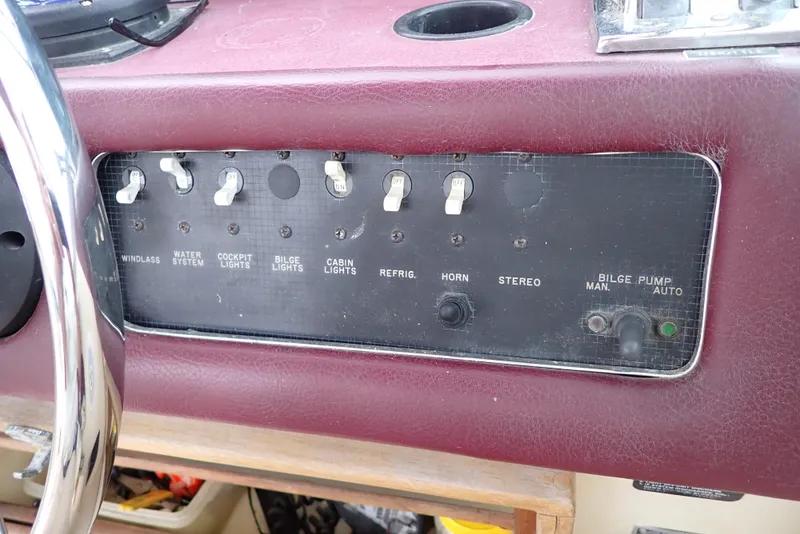 Slide: The Image of Control panel of a 1987 Sea Ray 300 Weekender boat with various switches. - 21