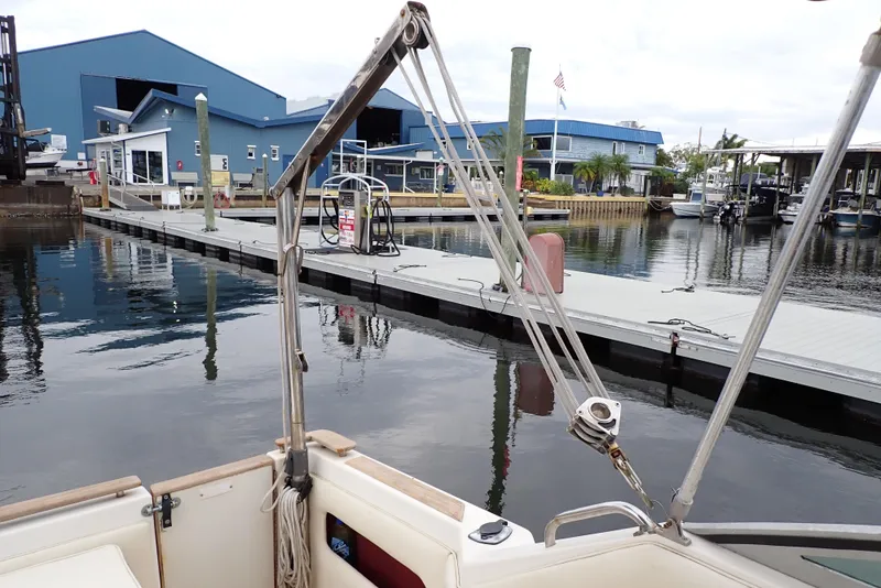 Slide: The Image of 1987 Sea Ray 300 Weekender docked at a marina with blue buildings in the background. - 24
