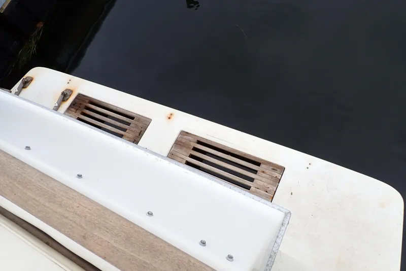 Slide: The Image of 1987 Sea Ray 300 Weekender boat deck with wooden slats and water view. - 28