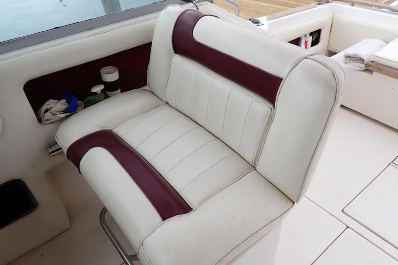 Slide: The Image of 1987 Sea Ray 300 Weekender boat seat with white and maroon upholstery. - 29