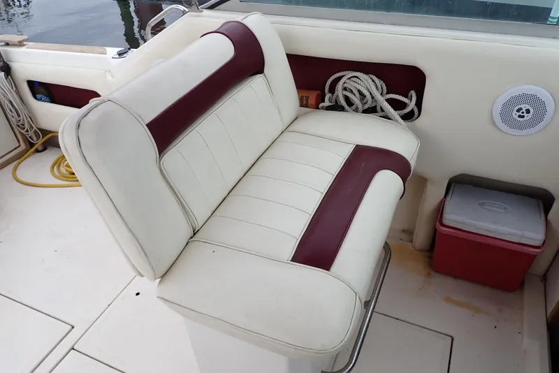 Slide: The Image of 1987 Sea Ray 300 Weekender boat interior with white and maroon seating, rope, and cooler. - 30
