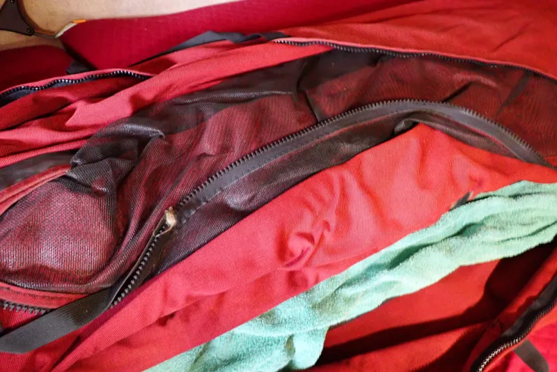 Slide: The Image of Red and green fabric with zippers, possibly boat upholstery for 1987 Sea Ray 300 Weekender. - 32