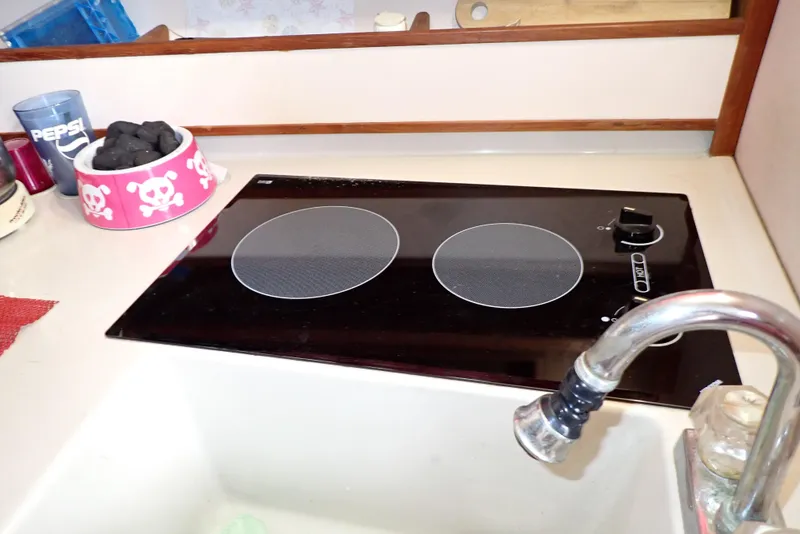 Slide: The Image of 1987 Sea Ray 300 Weekender kitchen with electric stove and sink. - 34