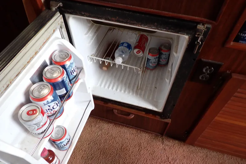 Slide: The Image of Mini fridge stocked with drinks inside a 1987 Sea Ray 300 Weekender boat. - 37