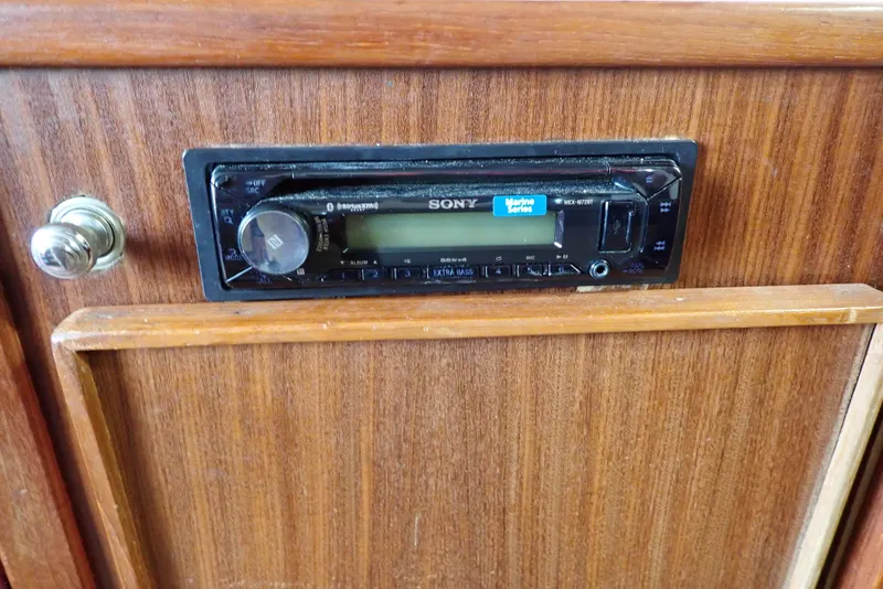 Slide: The Image of 1987 Sea Ray 300 Weekender interior with Sony stereo system on wooden panel. - 40