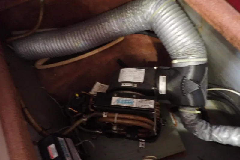 Slide: The Image of 1987 Sea Ray 300 Weekender engine compartment with ventilation system and mechanical components. - 45