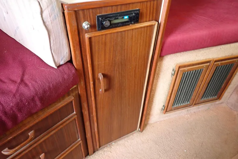 Slide: The Image of Interior of 1987 Sea Ray 300 Weekender with wood cabinetry and red upholstery. - 49