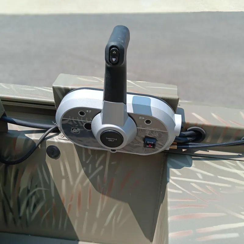 Slide: The Image of Control panel of 2025 Tracker Grizzly 1648 SC boat, featuring throttle and gear controls. - 10