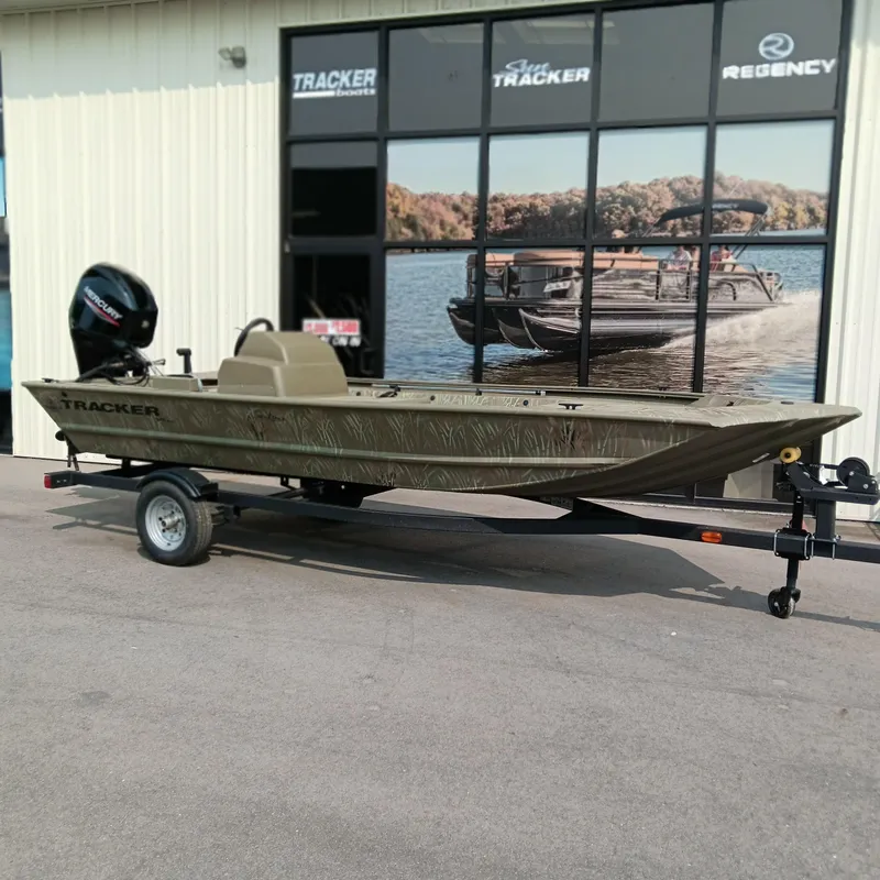 Slide: The Image of 2025 Tracker Grizzly 1648 SC boat on trailer outside dealership. - 2