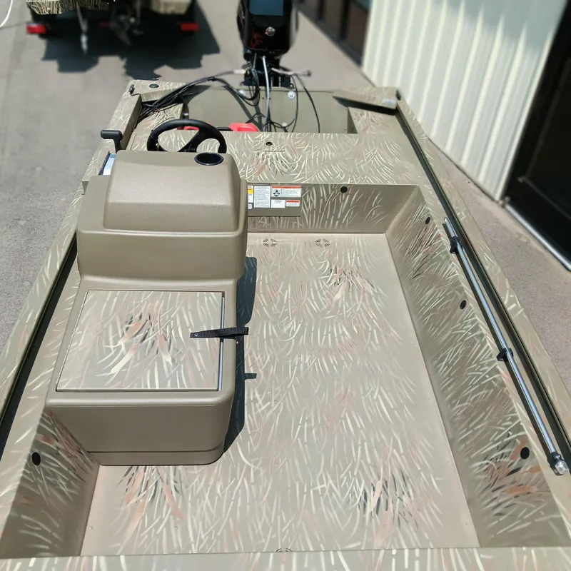 Slide: The Image of 2025 Tracker Grizzly 1648 SC boat interior with camouflage design and steering console. - 6