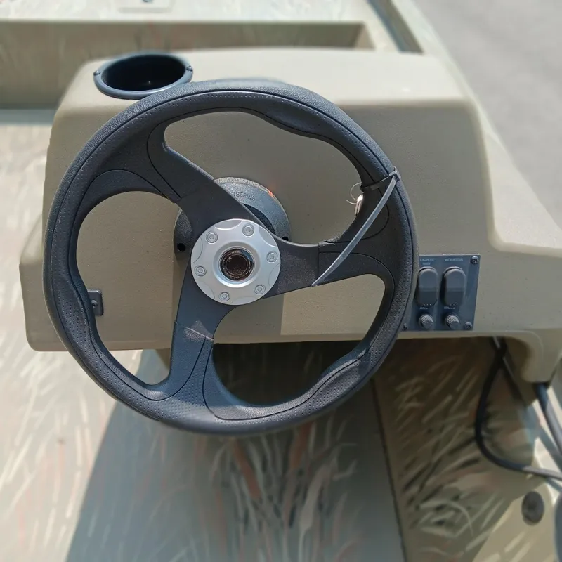 Slide: The Image of Steering wheel of 2025 Tracker Grizzly 1648 SC boat, featuring a simple dashboard design. - 9