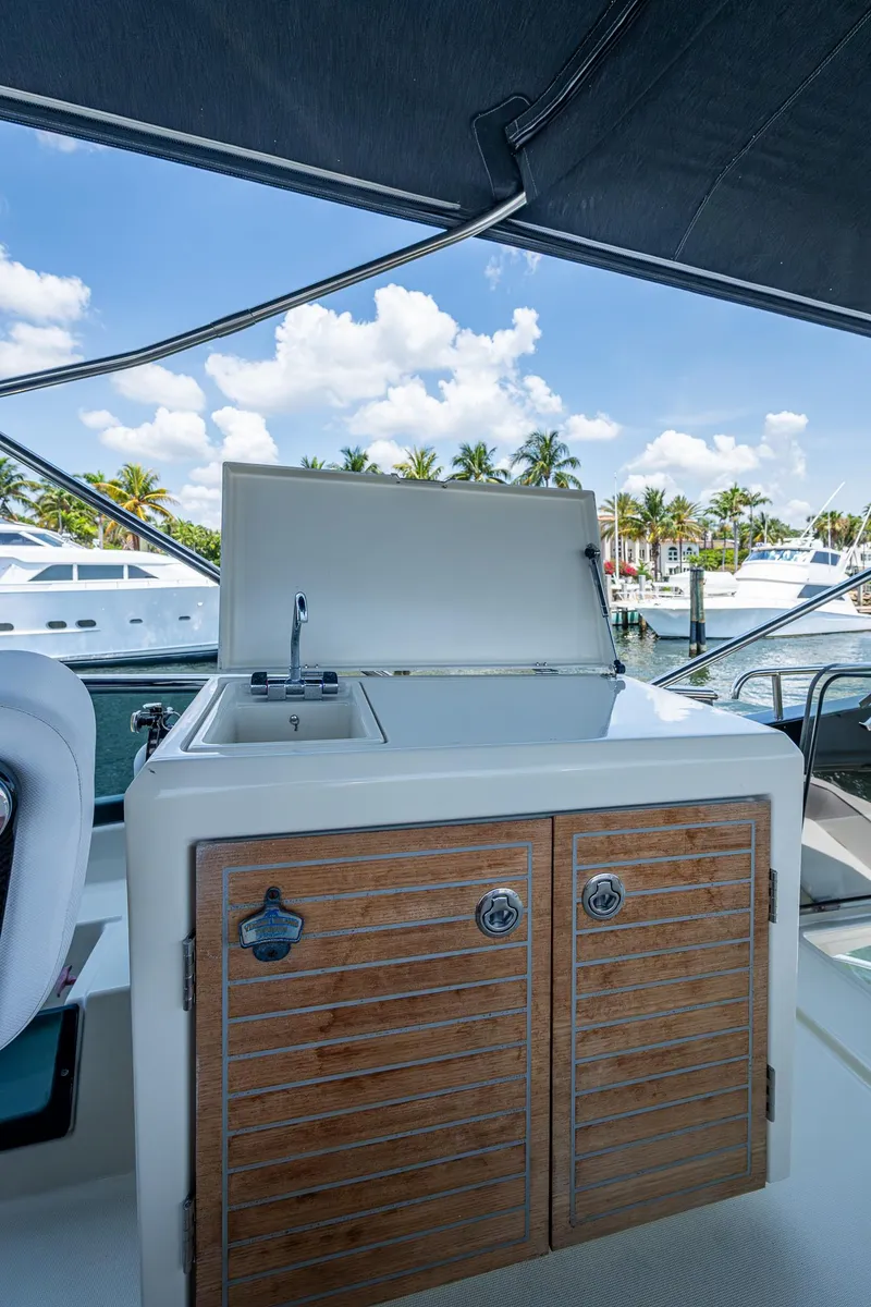 Slide: The Image of 2015 Beneteau Monte Carlo yacht with outdoor kitchenette, docked under a clear blue sky. - 30