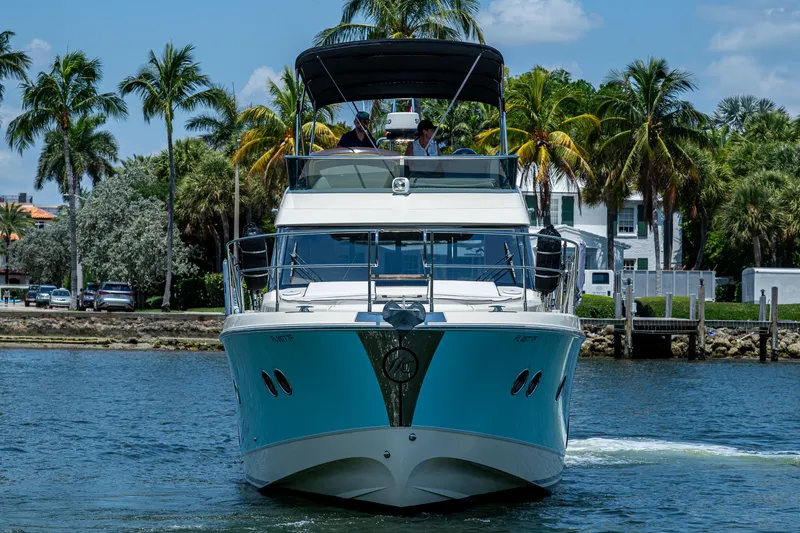 Slide: The Image of 2015 Beneteau MONTE CARLO yacht cruising on a sunny day with palm trees in the background. - 4